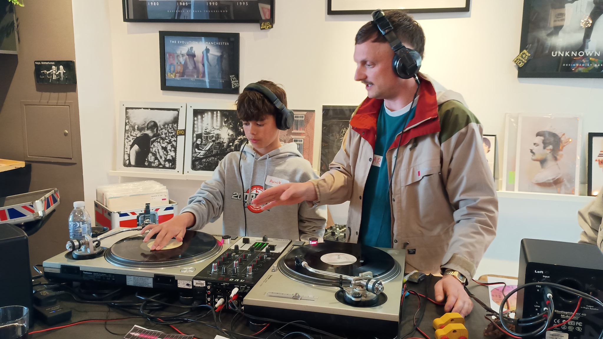 Young person learning to DJ with support during an Unknown Macc session in Macclesfield